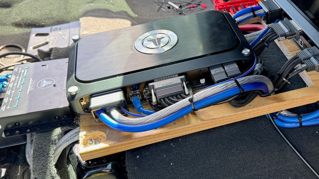 Close-up of electronic components with blue and silver wiring on a black surface